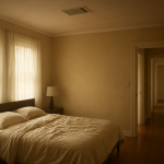 Upstairs bedroom with open door and subtle warm stuffy air